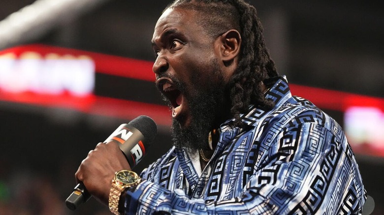 Oba Femi cuts a promo to Paul Heyman on the stage from the ring during an episode of "WWE Raw."