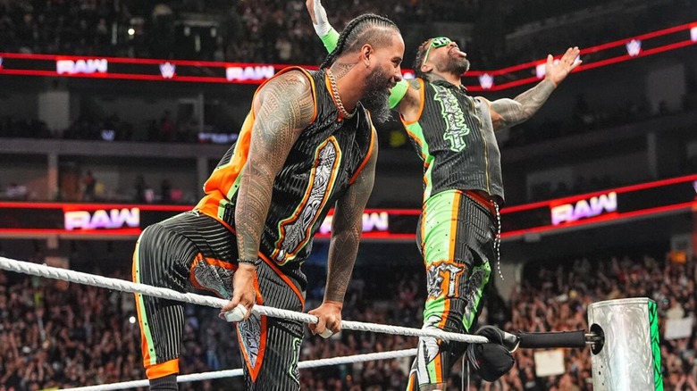 Jimmy and Jey Uso pose on the ropes during their entrance before a match on "WWE Raw."