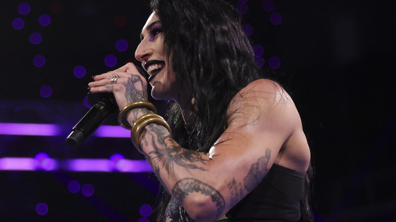 Rhea Ripley holding a microphone in her hand