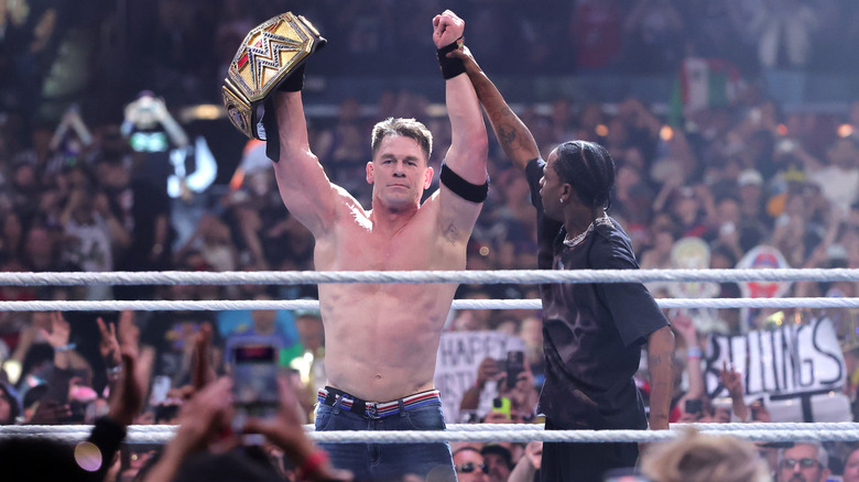 John Cena (L) celebrates with rapper Travis Scott after defeating Cody Rhodes for the Undisputed WWE Championship during WrestleMania 41 at Allegiant Stadium on April 20, 2025 in Las Vegas, Nevada.