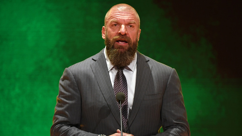 Paul Levesque AKA Triple H in front of a green background