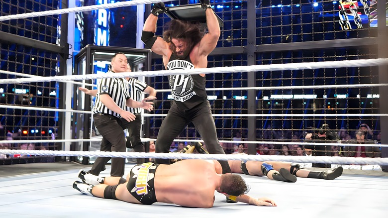 AJ Styles beats LA Knight with a chair