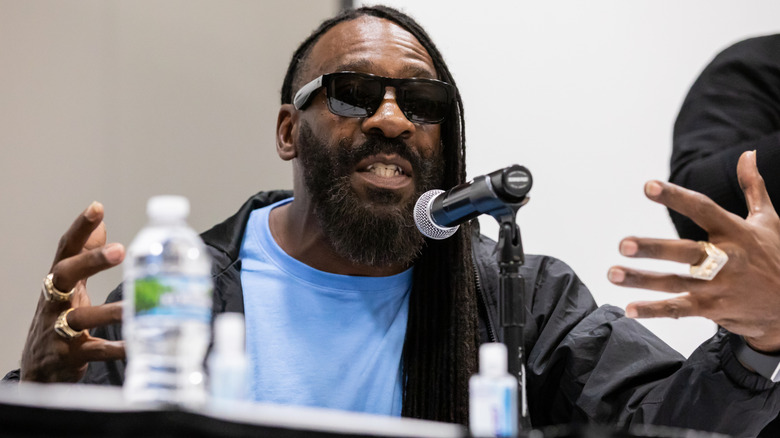 Booker T gesticulating while speaking on a panel