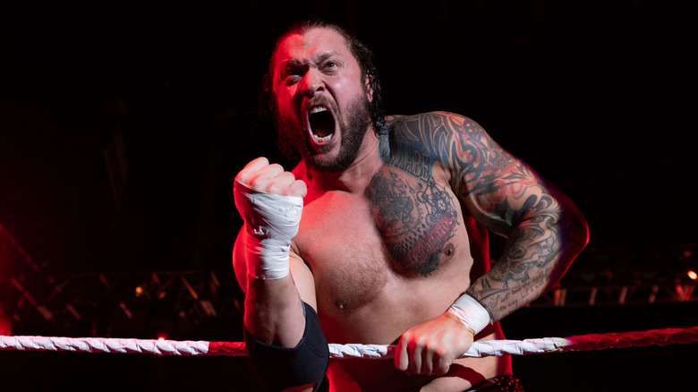 Karrion Kross shouting in wrestling ring with fist raised