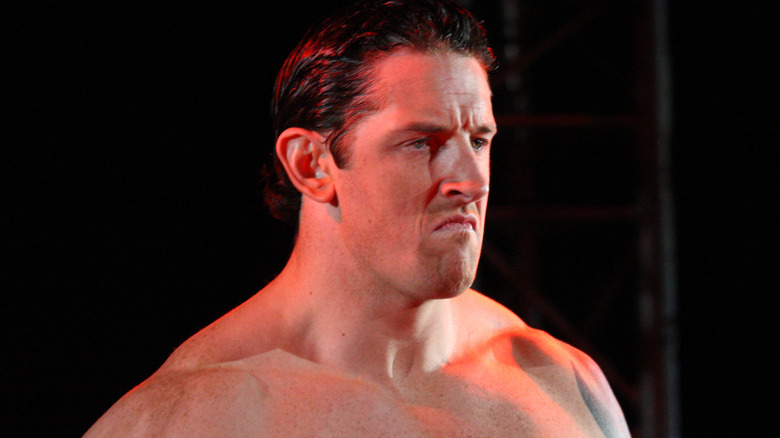 Wade Barrett scowling with no shirt on