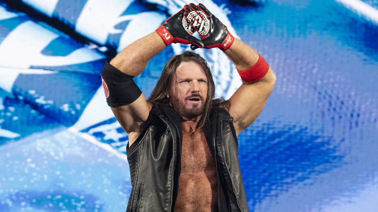 AJ Styles throws his hands up capturing his "Phenomenal One" pose