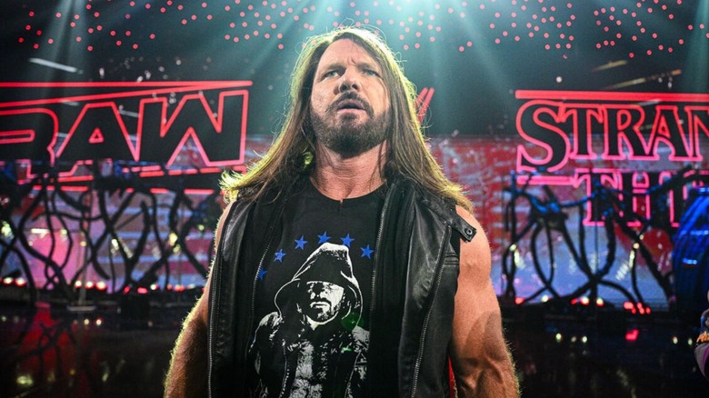 AJ Styles stares toward the ring from the stage during 