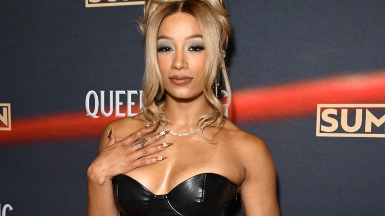 Mercedes Mone wearing a black dress