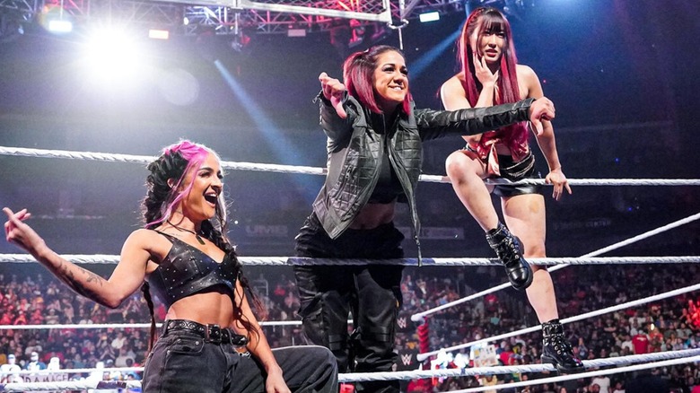 The original Damage CTRL lineup: Dakota Kai, Bayley, and Io Sky, in ring taunting the crowd