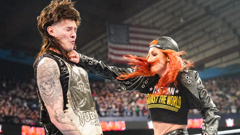 Becky Lynch punching Dominik Mysterio in the face