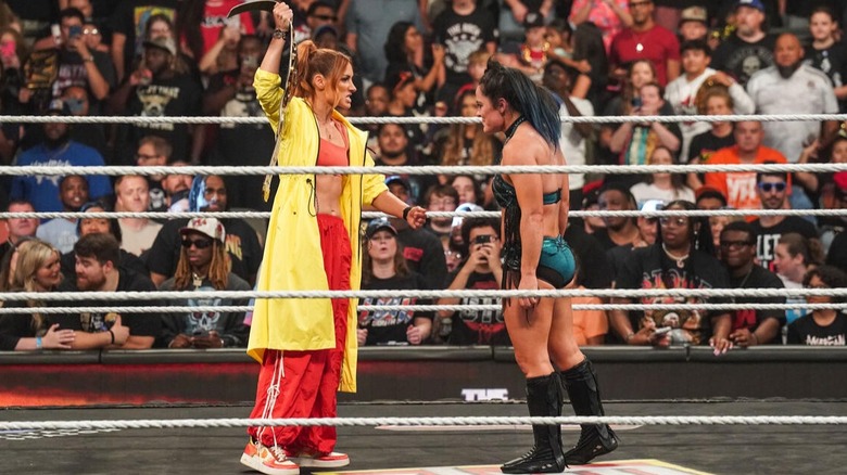 Becky Lynch sports a red and yellow outfit embracing the 