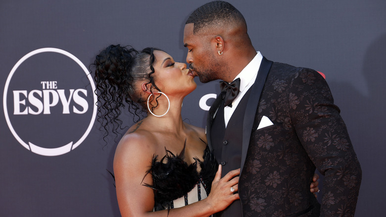 Bianca Belair and Montez Ford kiss on the red carpet