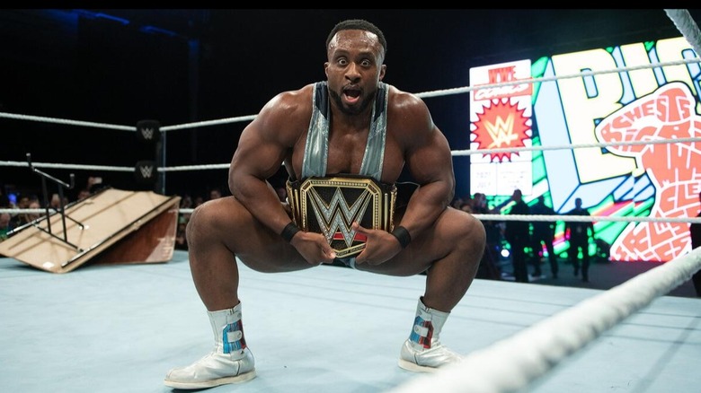 Big E poses with the WWE Championship after successfully retaining the title