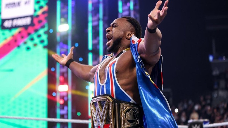 Big E poses in the ring, the WWE Championship around his waist, before a match against Roman Reigns.