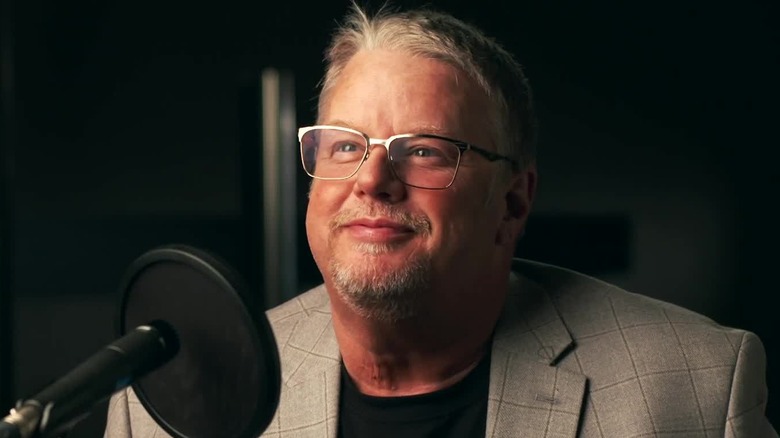 Bruce Prichard behind microphone