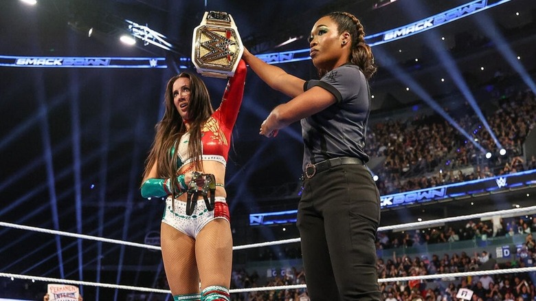 A referee holds up the arm of WWE Women's Champion Chelsea Green, who holds on to her protective face mask, after her victory over Nia Jax on the September 11, 2026 edition of 