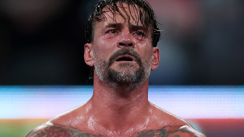 CM punk holding world heavyweight championship
