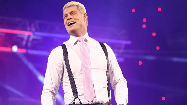 Cody Rhodes stands on the ropes and smiles toward the crowd during an episode of 