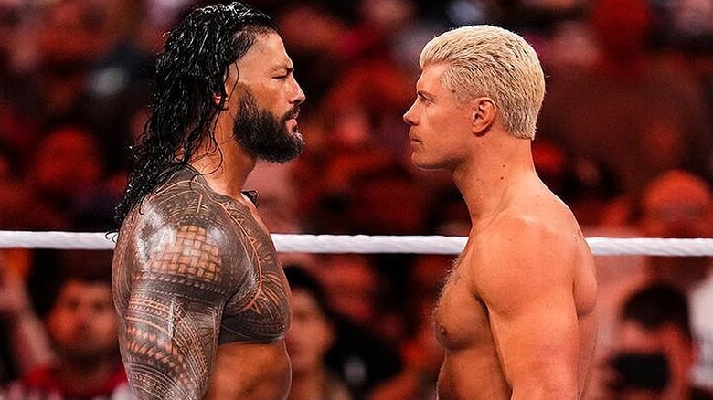Roman Reigns and Cody Rhodes having an intense stare-off during their WrestleMania 39 match.
