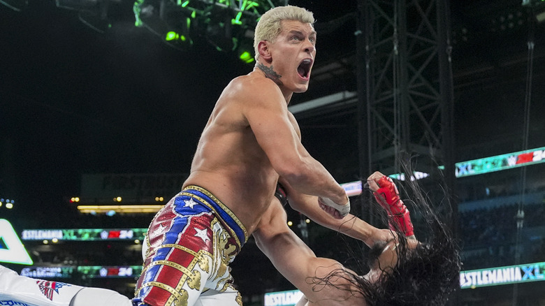 Cody Rhodes knocking down Roman Reigns at WWE WrestleMania 40