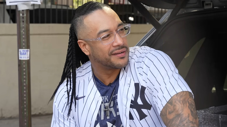 Damian Priest wearing glasses and a New York Yankees jersey