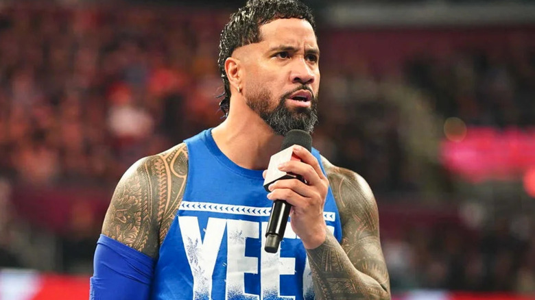 Jey Uso talking into a microphone