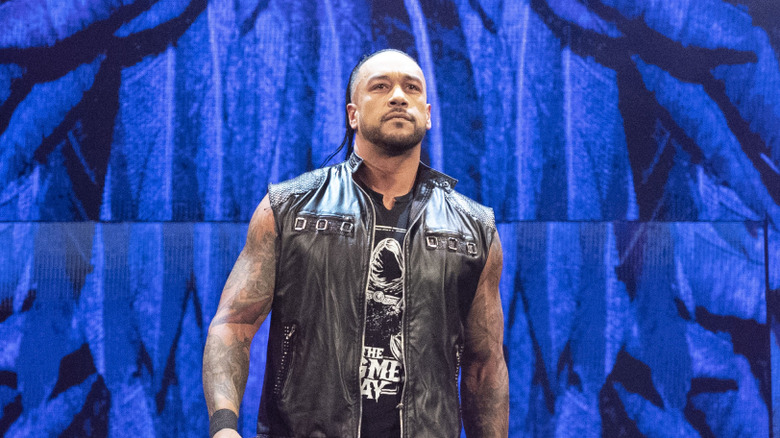Damian Priest stands confidently tall at the top of a WWE entrance ramp, embellishing his single's career after post-Judgment Day duties