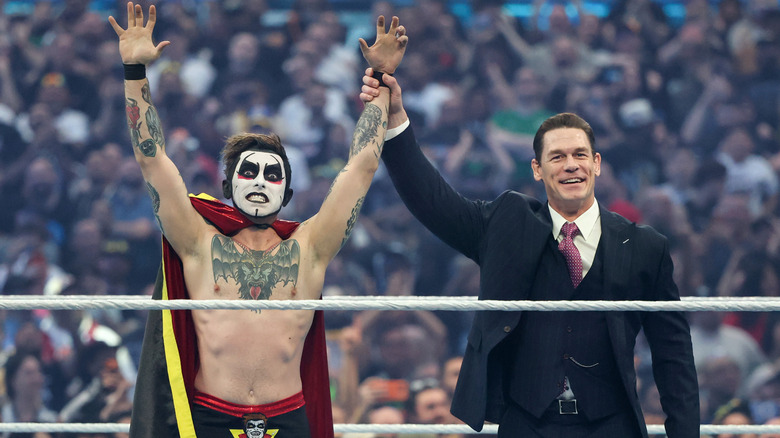 Host John Cena (R) lifts the hand of Danhausen during WrestleMania 42 at Allegiant Stadium on April 19, 2026 in Las Vegas, Nevada.