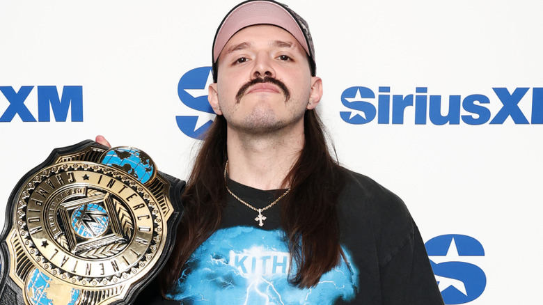 Dominik Mysterio wearing a cross necklace