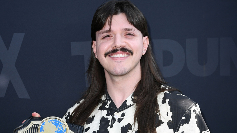 Dominilk Mysterio wearing a cow print shirt