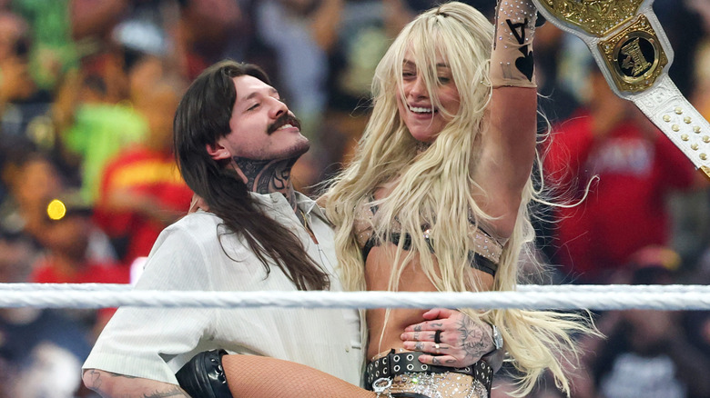 Dominik Mysterio holding Liv Morgan