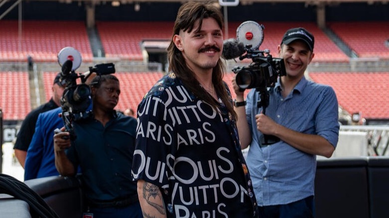 Dominik Mysterio loves hogging the spotlight, as camera crews follow him around a WWE ring documenting his decorated career