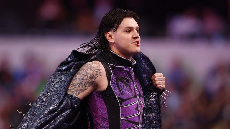 Dominik Mysterio takes off his jacket