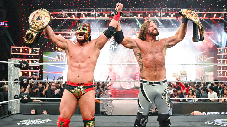 Dragon Lee and AJ Styles celebrating tag title win on WWE Raw