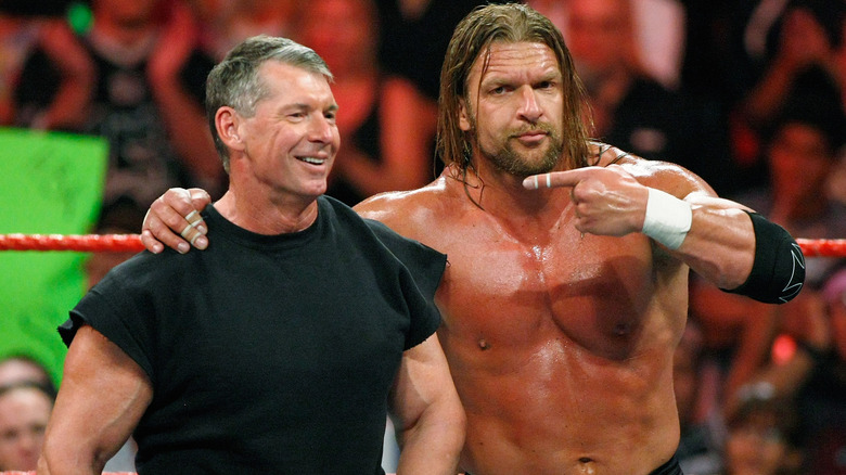 Vince McMahon and Triple H appear in the ring during 