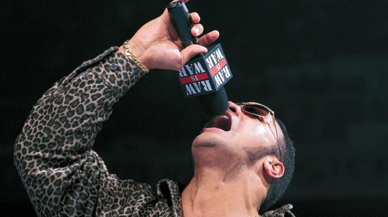 The Rock cuts a promo in the middle of the ring during an episode of "Raw is War."