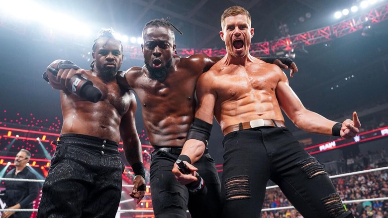 Grayson Waller poses with his newfound friends, The New Day, before a match on "WWE Raw."