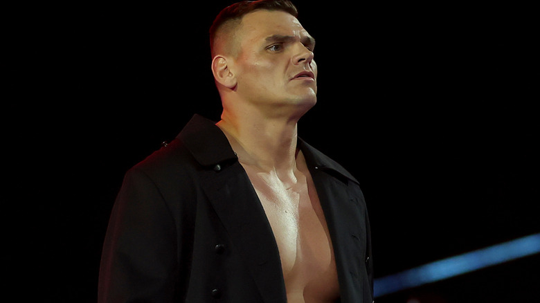 Gunther wearing a black ring coat