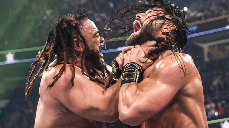 Jacob Fatu grabbing Roman Reigns by the throat during their World Heavyweight Championship match at Backlash 2026.
