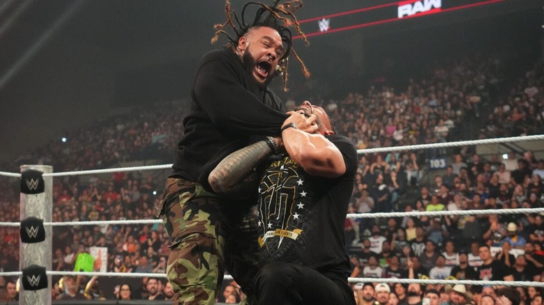Jacob Fatu locks in the Tongan Death Grip on Roman Reigns in the ring during an episode of 