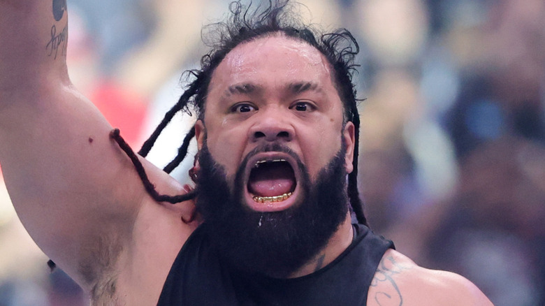 Jacob Fatu with his arm raised
