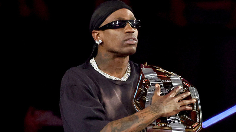 Travis Scott holding a championship belt