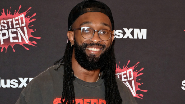 Chris Bey wearing sunglasses and smiling