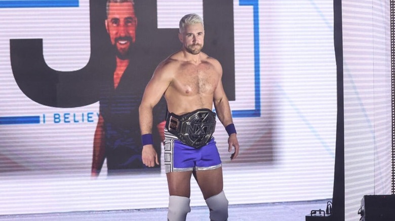 Then-NXT Champion Joe Hendry poses on stage before heading down to the ring for a match at 