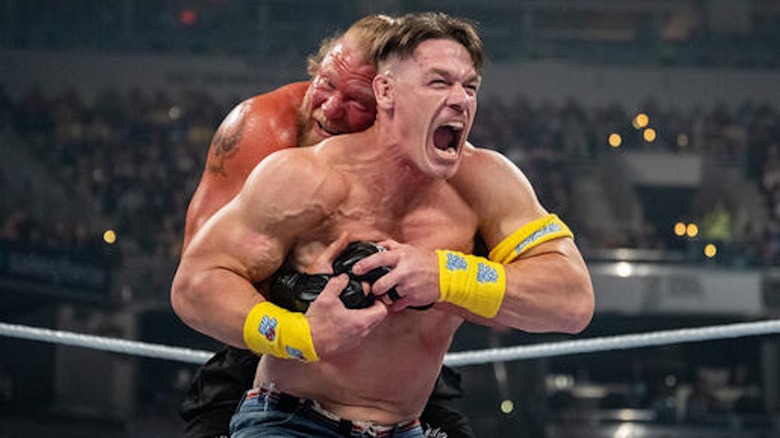 John Cena tries to escape the grasp of Brock Lesnar.