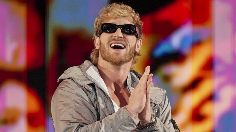 Logan Paul wearing sunglasses and rubbing his hands together
