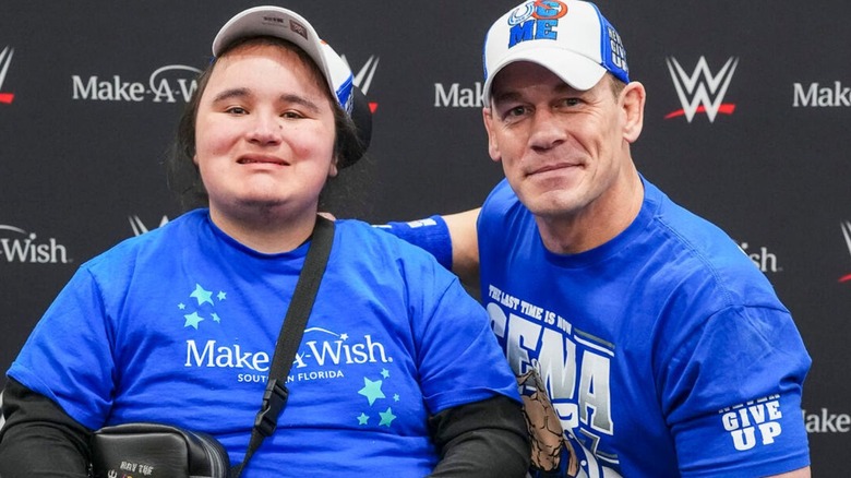 John Cena poses with a child from the Make A Wish program backstage at the 2025 Royal Rumble.