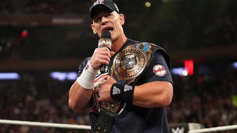 John Cena cuts a promo, Intercontinental Championship on his shoulder, during an episode of 