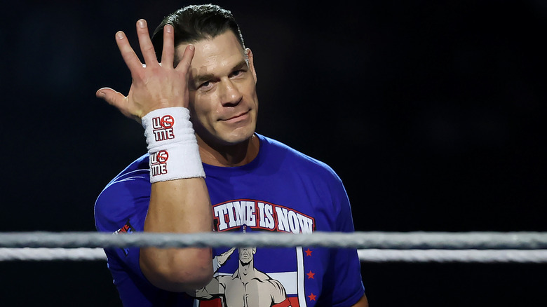 John Cena hits his iconic "you can't see me" gesture in the ring.