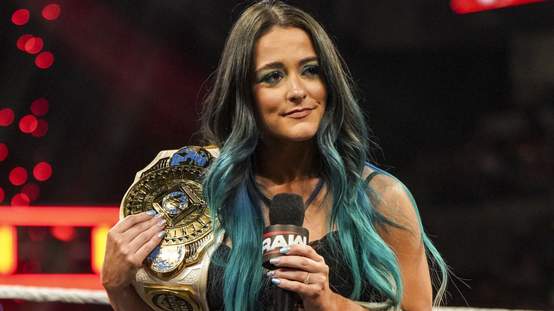 Lyra Valkyria standing in WWE ring waiting to address fans in attendance